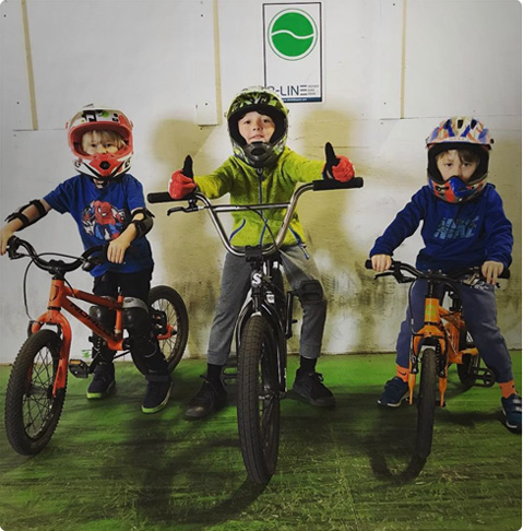 three kids striking a pose on their bikes