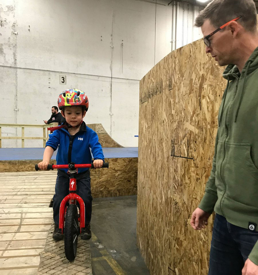 parent overseeing child riding their bike