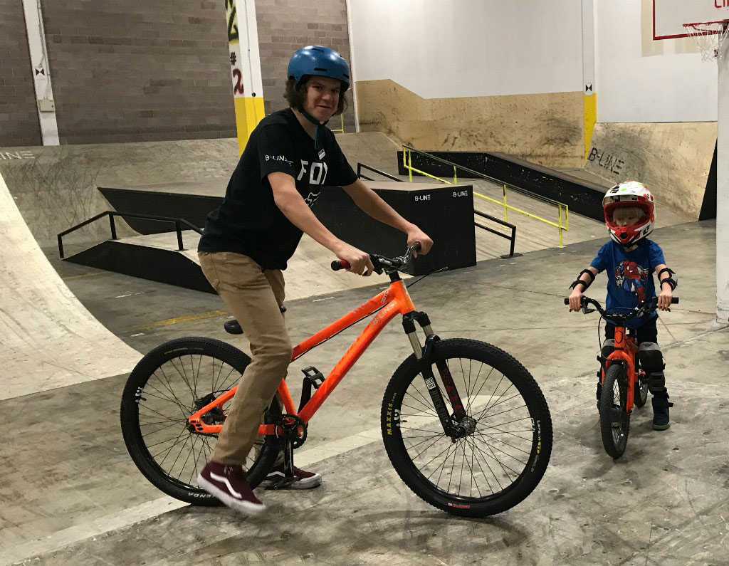 man and child on their bikes inside the facility